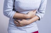 Woman holding stomach in pain