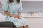 Woman sitting on table in doctor's office