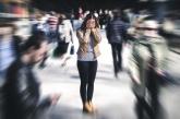 Woman standing in crowd holding her face