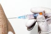 gloved hand giving injection