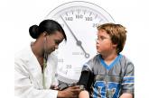 Child with blood pressure cuff