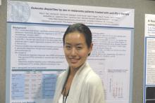 Dr. Katy Tsai stands at her poster.