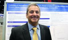 Dr. Pablo Pergola stands in front of his poster presentation.