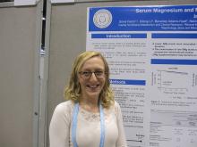 Dr. Silvia Ferre stands in front of her poster presentation.