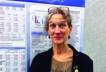 Dr. Anne Berg stands before her poster presentation at the annual meeting of the American Epilepsy Society.