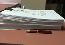 A large stack of papers for a research study protocol.