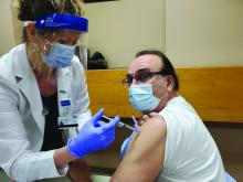 Dr. Michael E. Pichichero receives his first SARS-CoV-2 shot of the Moderna vaccine in January 2021.