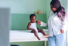 African American Baby Girl Sitting at the Doctor's Office and Waiting for the Examination