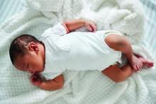 Newborn baby sleeping in supine position