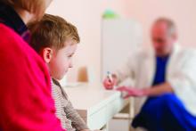 Pediatrician writes a prescription for boy