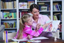 Female child psychologist working with a little girl