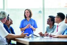 Medical staff group meeting at a table