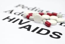 Pills spread across the words HIV AIDS