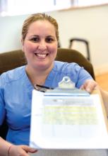 A smiling nurse holds a clipboard.