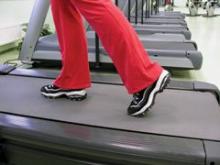 Person walking on treadmill is shown.