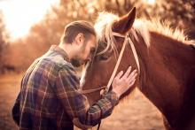 A man stands with his horse