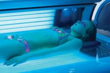 Girl lying on tanning bed