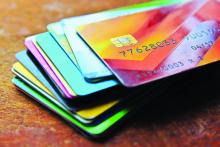 A stack of colorful credit cards on a table.