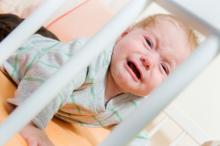 Baby crying in a crib