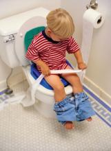 A boy on a toilet.