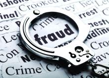 A handcuf laying over a paper, highlighting the word fraud.