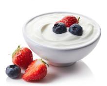 A bowl of greek yogurt with berries.