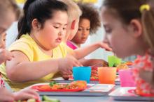 An overweight child at a lunch table