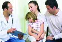 Doctor speaking with parents who are holding young girl.