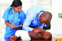 Doctor and nurse doing a checkup on a baby