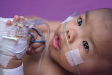Photo features an infant hooked up to oxygen