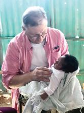 Dr. Ron Smith examines a baby in Haiti