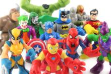 Small, colorful superhero statues are gathered for a superhero convention