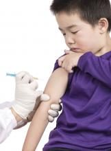 A young boy receives a vaccine injection.