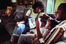 A young family consults with a doctor by using a digital tablet