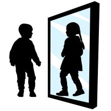 Boy sees a girl in the reflection of the mirror.