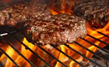 Beef burger on barbecue flame grill