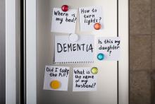 Dementia reminder notes on refrigerator.
