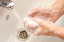 A person lathering her hands with soap to wash