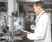 Dr. James Marcin of UC Davis Children's Hospital, visits with a young patient through a two-way video. Dr. Marcin leads the Pediatric Telemedicine Program, which provides telemedicine consultations to seriously ill pediatric patients in remote hospitals.