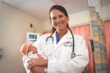 Dr. Brigid McCue, an ob.gyn hospitalist, holds one of her patients. Dr. McCue helped establish the ob.gyn hospitalist program at Beth Israel Deaconess Hospital-Plymouth.