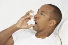 A man uses an inhaler