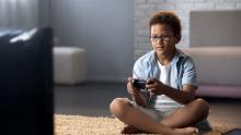 child playing video game on tv